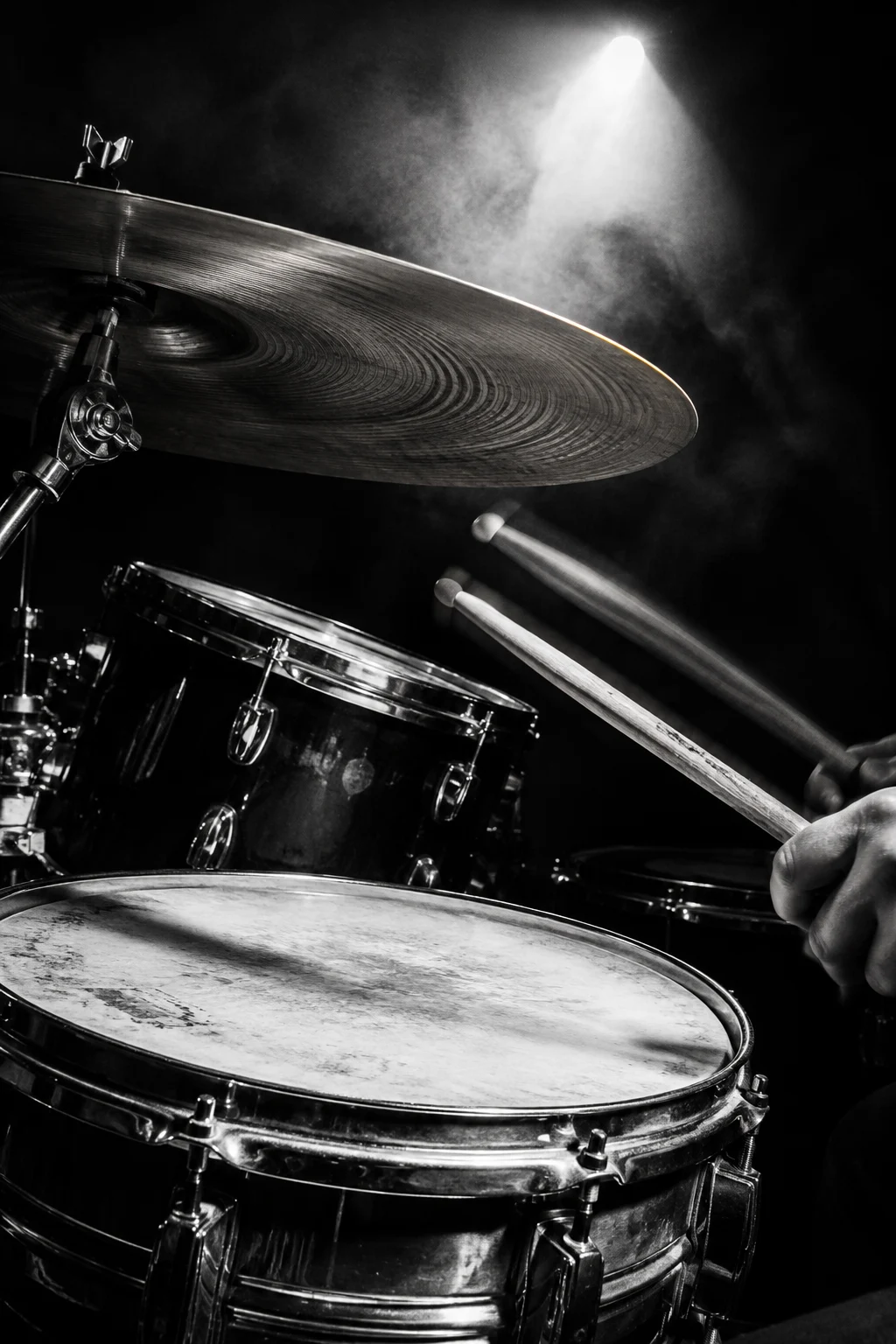Monochrome drum study: a worn snare and cymbal with drumsticks in motion. Concept artwork.